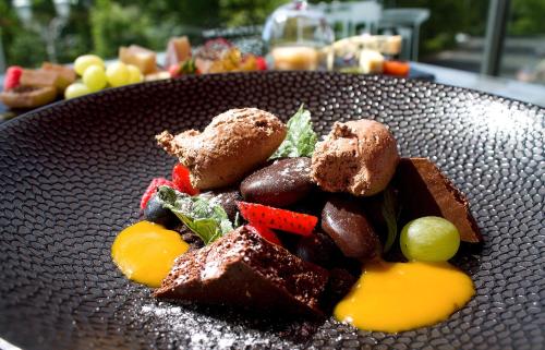 a plate of food on a table at Villa Patriot Boutique Hotel in Mariánské Lázně