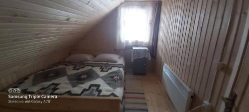 a small room with a bed in a attic at У Андрушка in Vorokhta