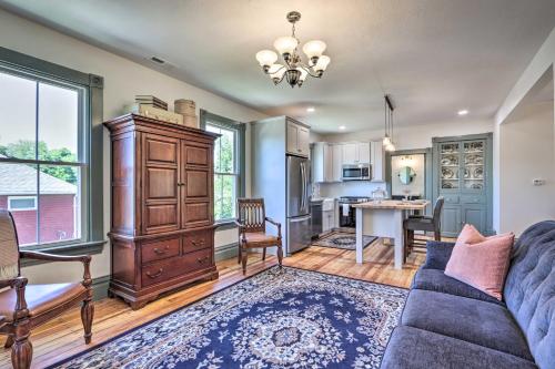 a living room with a blue couch and a kitchen at The Ruebling House Cozy Defiance Apartment! in Defiance