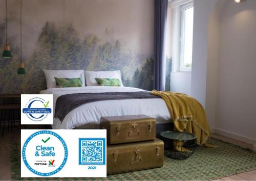 a bedroom with a bed with a suitcase next to it at Ocean Center Apartments in Cascais