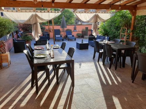 a dining area with tables, chairs and tables at BioBenessere B&B Moto & Bike Parking in Arezzo
