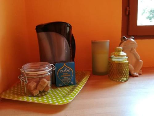 a counter with a blender and a jar of food at Chambres d'Hôtes Les Jourdets à l'Abri de l'Orée in Lairière