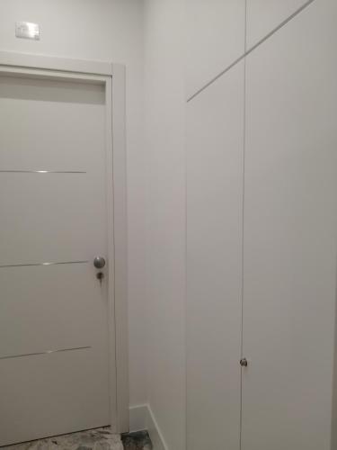 a white closet with two doors in a room at Insieme al mare in Praia a Mare