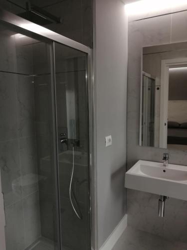 a bathroom with a glass shower and a sink at Insieme al mare in Praia a Mare