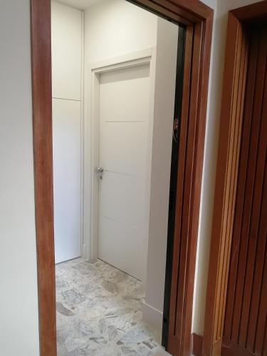 a hallway with a white door and a tile floor at Insieme al mare in Praia a Mare