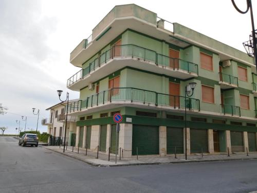 a green building on the side of a street at Insieme al mare in Praia a Mare