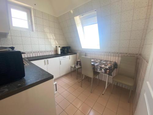 a small kitchen with a table and chairs in it at Barbara Vendégház in Balatonfüred