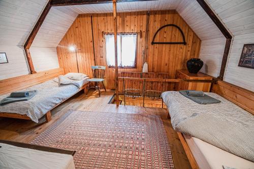 a room with two beds and a table in it at Postaja Mir in the heart of Triglav National Park in Bohinj