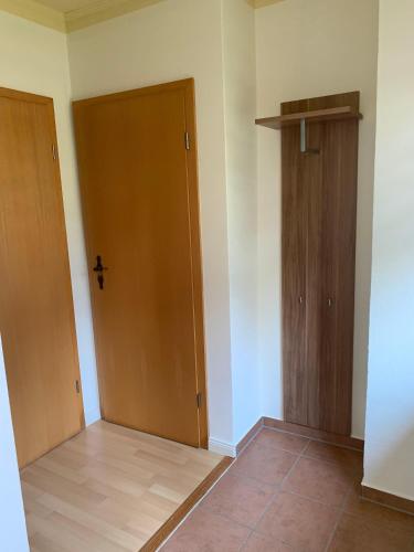 a room with two wooden doors and a tile floor at Ferienwohnung-in-Stadtmitte in Teterow