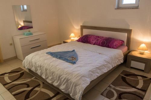 a bedroom with a bed and a dresser and a mirror at Apartment in Mundanije with balcony, air conditioning, WiFi, washing machine (4912-3) in Mundanije