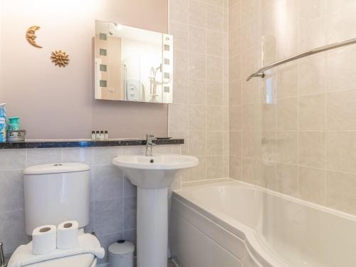 a bathroom with a sink and a toilet and a bath tub at Pass the Keys Stunning 1BD flat in City Centre in Edinburgh