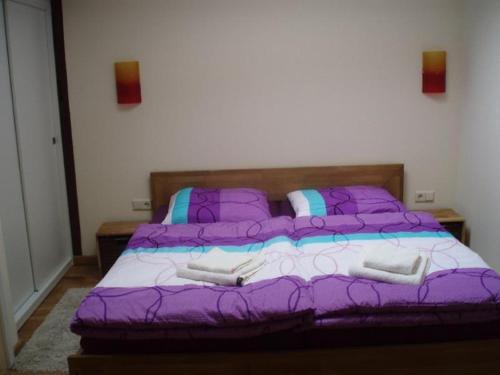 a purple bed with two pillows on it in a bedroom at Stadtferienwohnung in Teterow