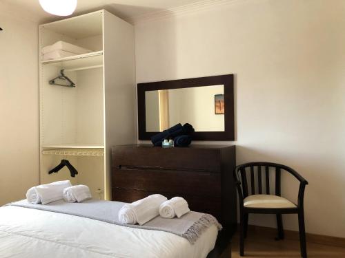 a bedroom with a bed and a mirror and a chair at Charming Villa in Resende with Private Pool in Resende