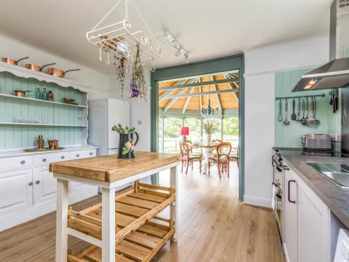 a kitchen with a table and a dining room at Pretty Three Bedroomed home near the Beach - Pass the Keys in Chichester