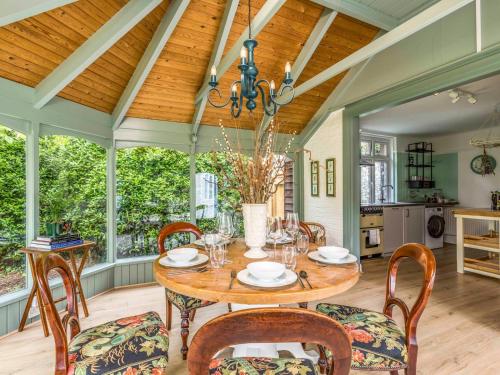 a dining room with a table and chairs at Pretty Three Bedroomed home near the Beach - Pass the Keys in Chichester