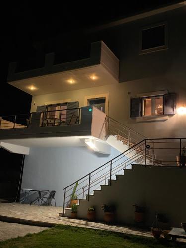 a house with a staircase in the night at Elina's Maisonette in Episkopos