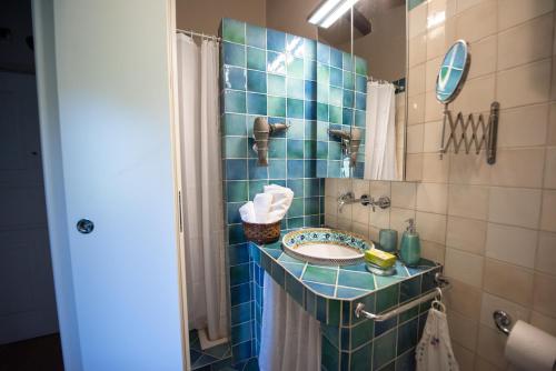 a bathroom with a sink and a mirror at Mansarda Relax Wellness Gym & Spa in Taormina