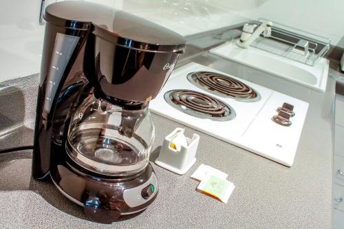 a blender sitting on a counter next to a stove at El Polo Hotel & Suites in Lima