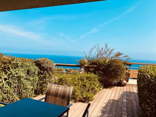 a patio with a table and chairs and the ocean at Sunny Home Costa Plana-Monaco -Cap D'Ail in Cap d'Ail