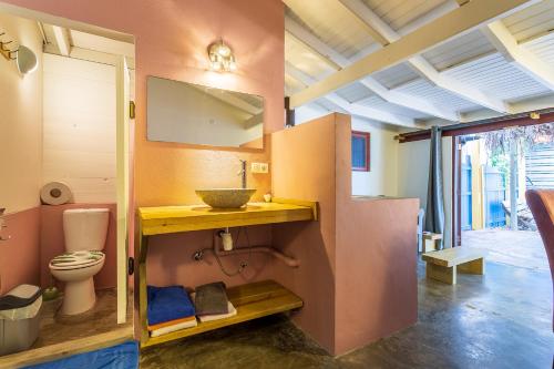 a bathroom with a toilet and a sink at Beach Studio Flaka at Lac Bay in Kralendijk
