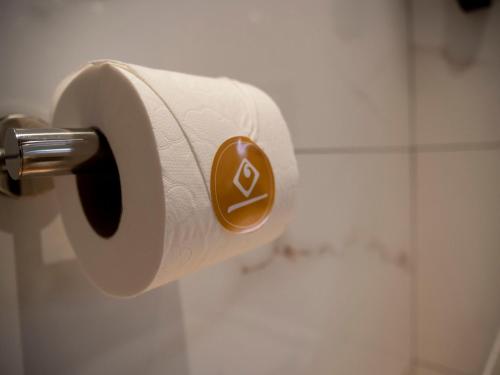 a roll of toilet paper on a holder in a bathroom at Hotel Palacio La Marquesa 4 Estrellas SUP in Teruel