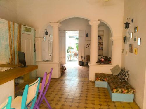 a living room with colorful chairs and a couch at Hostal Españolete in Santa Marta