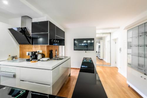 a kitchen with white cabinets and a counter top at Luxury Apartment Set in Split