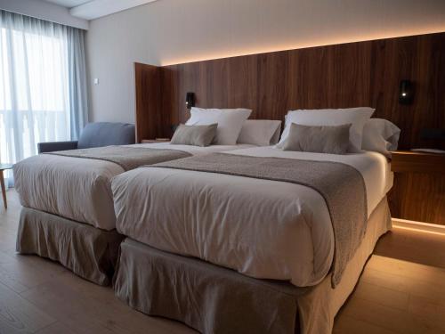a large bed in a hotel room with two large beds at Hotel Palacio La Marquesa 4 Estrellas SUP in Teruel
