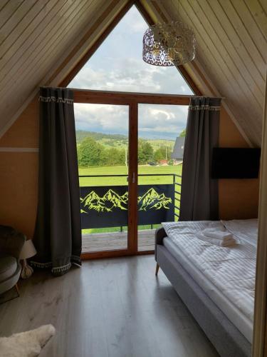 a bedroom with a large window with a view at WIOSKA RUSIŃSKI in Bukowina Tatrzańska