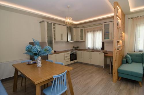 a kitchen and dining room with a table and chairs at L & A - GUEST HOUSE in Skala Potamias