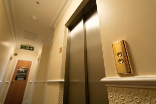 a door that is open to a bathroom at Days Inn Hyde Park in London