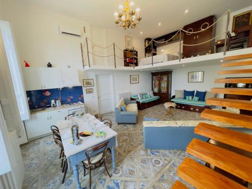 a living room with a table and blue chairs at Coco's Apartment in Meta