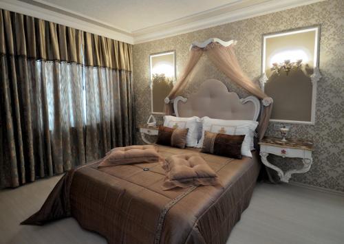 a large bedroom with a large bed with a canopy at Grand Atakum Hotel in Samsun