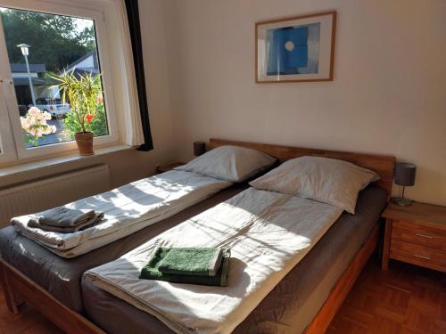 two beds in a bedroom with a window at Haus Finisberg in Flensburg