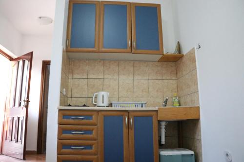 a kitchen with wooden cabinets and a sink at Apartment Sole in Poreč