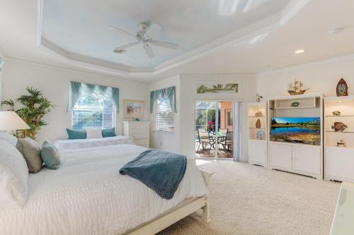 a bedroom with a bed and a ceiling fan at The Joint Venture - Cape Coral - Roelens Vacations in Cape Coral