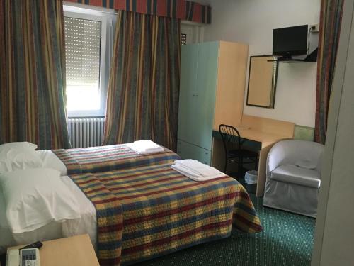Postel nebo postele na pokoji v ubytování Hotel Astoria