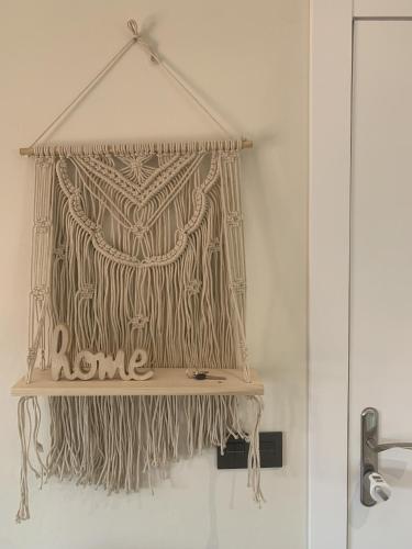 a sign that says home hanging on a wall at El Ático in Astorga