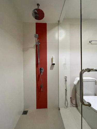 a shower with a red door in a bathroom at Huvan Beach Hotel at Hulhumale in Hulhumale