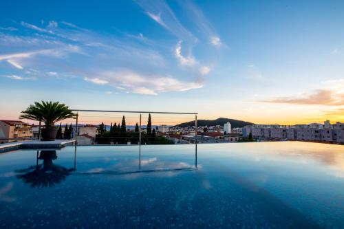 a large swimming pool with a view of a city at Art Hotel in Split