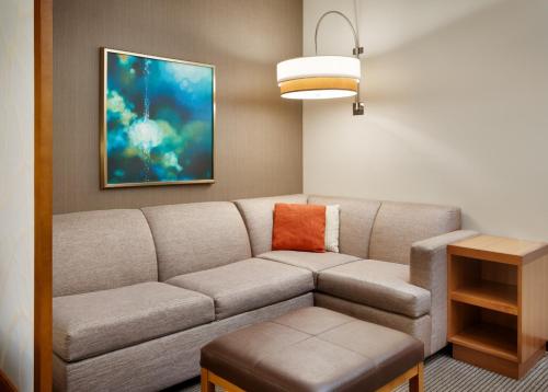 a living room with a couch and a table at Hyatt Place Miami Airport East in Miami