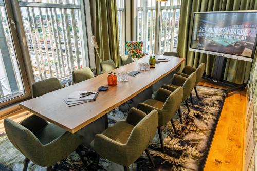 a conference room with a large table and chairs at Me and All Hotel ulm, by Hyatt in Ulm