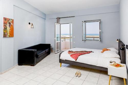 a bedroom with a bed and a view of the ocean at Sole Mare Seaside Apartments in Gouves