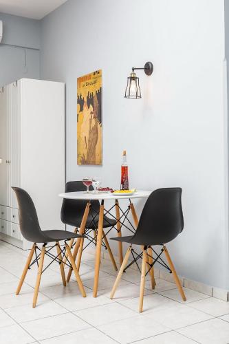 a dining room with a table and two chairs at Sole Mare Seaside Apartments in Gouves