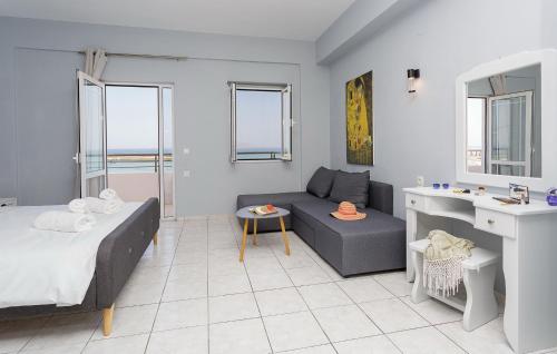 a living room with a bed and a couch at Sole Mare Seaside Apartments in Gouves