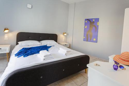 a bedroom with a large bed with a black headboard at Sole Mare Seaside Apartments in Gouves