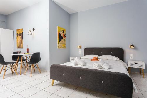 a large bed in a room with a table and chairs at Sole Mare Seaside Apartments in Gouves