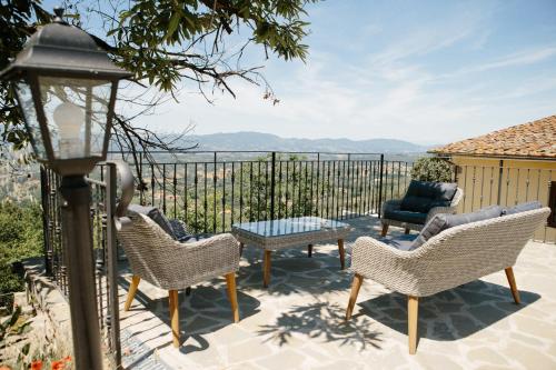 a patio with chairs and a table with a view at Agriturismo I Millepini in Case Malva