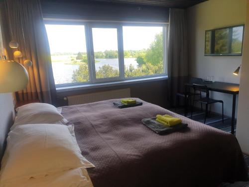 um quarto com uma cama com duas toalhas em Ilmatsalu Motell em Ilmatsalu