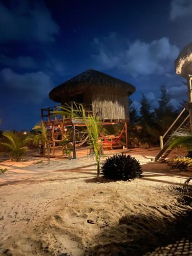 a hut on the beach at night at Cabanadu Preá Kite in Prea